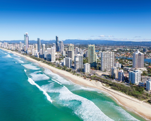 An aerial view of the Gold Coast skyline and beaches, highlighting the dynamic real estate scene for 'Gold Coast property market predictions 2024'.