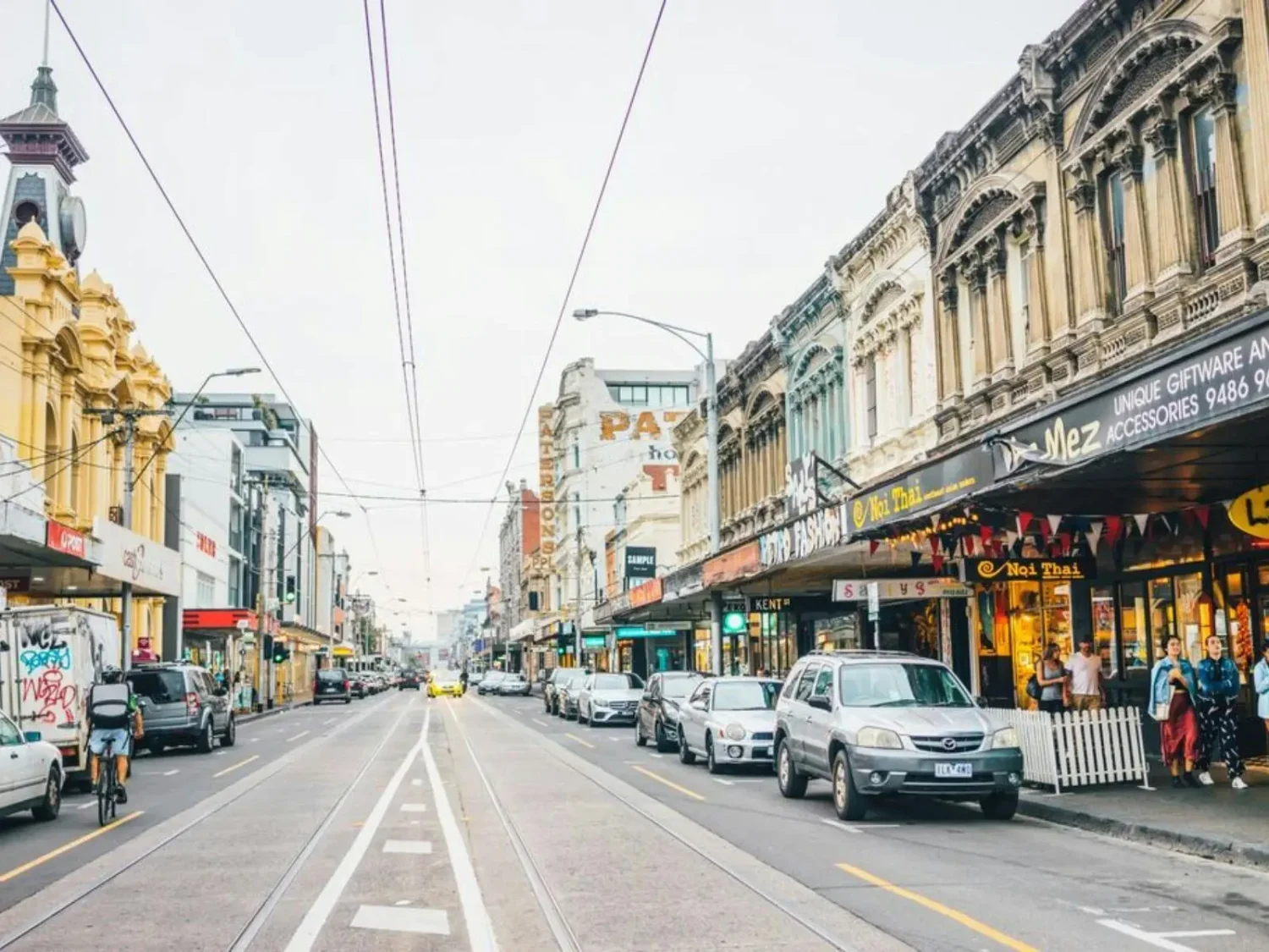 Fitzroy street scene lined with heritage shopfronts and cafés, one of Melbourne's most heritage-protected and tightly held inner-city suburbs